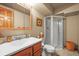 Traditional bathroom with a glass door shower, vanity with sink and toilet at 5723 S Everett Way, Littleton, CO 80123