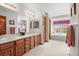 Large bathroom features double sinks, wood cabinets, tub and window with views at 5723 S Everett Way, Littleton, CO 80123