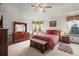 Cozy bedroom with neutral carpet, ceiling fan, dresser, and bench at 5723 S Everett Way, Littleton, CO 80123