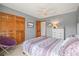 Cozy bedroom with closet, dresser, queen size bed and a purple accent chair at 5723 S Everett Way, Littleton, CO 80123