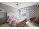 Comfortable bedroom features a queen size bed, ceiling fan and accent chair at 5723 S Everett Way, Littleton, CO 80123