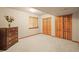 Bedroom with a window and built-in closet featuring wooden doors at 5723 S Everett Way, Littleton, CO 80123