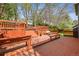 Multi-level wooden deck with built-in seating and stairs leading to the yard at 5723 S Everett Way, Littleton, CO 80123