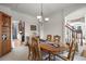 Elegant dining room featuring a classic chandelier, wood table, and staircase access at 5723 S Everett Way, Littleton, CO 80123