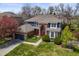 Stunning two-story home with a combination brick and blue siding, professional landscaping, and a two-car garage at 5723 S Everett Way, Littleton, CO 80123