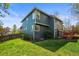 Two-story home with blue siding, large windows, and a well-maintained lawn at 5723 S Everett Way, Littleton, CO 80123
