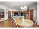 Spacious eat-in kitchen featuring wooden cabinets, black appliances, and a stylish backsplash at 5723 S Everett Way, Littleton, CO 80123