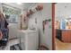 Well-lit laundry room with patterned floor, washer, dryer, and storage shelves at 5723 S Everett Way, Littleton, CO 80123