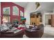 Inviting living room featuring a cozy brick fireplace, vaulted ceiling, and built-in shelving at 5723 S Everett Way, Littleton, CO 80123