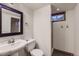 Cozy bathroom with a pedestal sink, toilet, and a shower stall with window for natural light at 649 Nucla Way, Aurora, CO 80011