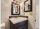 Bathroom with modern fixtures, a framed mirror, and sleek vanity at 649 Nucla Way, Aurora, CO 80011