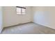 Empty bedroom with neutral carpet, clean walls, and a bright window at 649 Nucla Way, Aurora, CO 80011