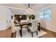 Cozy dining room with a modern chandelier and a view into the living room at 649 Nucla Way, Aurora, CO 80011