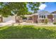 Charming brick home featuring a well-manicured lawn and welcoming entrance at 649 Nucla Way, Aurora, CO 80011