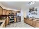 Modern kitchen with stainless steel appliances and ample countertop space at 649 Nucla Way, Aurora, CO 80011