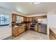 Well-equipped kitchen featuring stainless steel appliances and oak cabinetry at 649 Nucla Way, Aurora, CO 80011