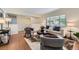 Bright living room featuring hardwood floors, a large window, and stylish decor at 649 Nucla Way, Aurora, CO 80011