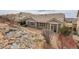 Backyard view featuring rock garden, wooden deck, and the exterior of the home at 2342 Bellavista St, Castle Rock, CO 80109