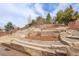 Well-manicured backyard featuring terraced landscaping with decorative rock and retaining walls at 2342 Bellavista St, Castle Rock, CO 80109