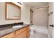 Bathroom with bathtub, shower, tile surround, wood vanity with granite countertop, and tile floors at 2342 Bellavista St, Castle Rock, CO 80109