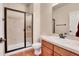 Clean bathroom with hardwood floors, a glass-enclosed shower, and a vanity with a white countertop at 2342 Bellavista St, Castle Rock, CO 80109