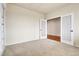 Neutral carpeted bedroom with natural light and white trim, connected by glass panel double doors at 2342 Bellavista St, Castle Rock, CO 80109