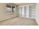 Bright carpeted bedroom with a large window and built-in white shelving, perfect for storage at 2342 Bellavista St, Castle Rock, CO 80109