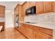 Beautiful kitchen featuring hardwood floors, quartz countertops, and stainless steel appliances at 2342 Bellavista St, Castle Rock, CO 80109