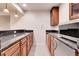 This kitchenette features granite countertops, wood cabinets, stainless steel microwave, and tile flooring at 2342 Bellavista St, Castle Rock, CO 80109