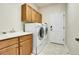 Functional laundry room with a sink, cabinetry, and modern washer and dryer units at 2342 Bellavista St, Castle Rock, CO 80109