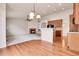 Open concept living room with a fireplace, carpet, and hardwood floors leading to the kitchen at 2342 Bellavista St, Castle Rock, CO 80109