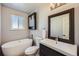 Bathroom with a free-standing tub and updated vanity at 209 S Pembrook St, Castle Rock, CO 80104