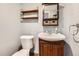 Small bathroom with pedestal sink and wood shelving at 209 S Pembrook St, Castle Rock, CO 80104