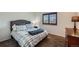 Cozy bedroom with plaid bedding and a window with plantation shutters at 209 S Pembrook St, Castle Rock, CO 80104