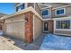 Front entry with brick columns and a double-car garage at 209 S Pembrook St, Castle Rock, CO 80104