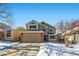 Two-story house with attached garage, brick accents, and snow-covered landscaping at 209 S Pembrook St, Castle Rock, CO 80104