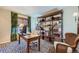 Home office features built-in shelving, a desk, and stylish rug at 209 S Pembrook St, Castle Rock, CO 80104