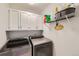 Laundry room with washer, dryer, and ample cabinet storage at 209 S Pembrook St, Castle Rock, CO 80104