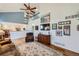 Two-story living room with hardwood floors, a fireplace, and a loft area at 209 S Pembrook St, Castle Rock, CO 80104