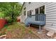 Backyard with a deck, a wooden fence, mature trees and grass at 1241 S Akron Way, Denver, CO 80247