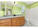 Bright bathroom featuring granite counters, wood cabinets and a shower over tub at 1241 S Akron Way, Denver, CO 80247