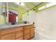 Bathroom with a double sink vanity, granite counters, a tub, a shower and tile floors at 1241 S Akron Way, Denver, CO 80247