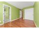 Bright bedroom featuring hardwood floors, closet space, and an adjoining bathroom at 1241 S Akron Way, Denver, CO 80247