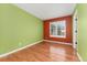 This bedroom has hardwood floors and a window view to the neighborhood at 1241 S Akron Way, Denver, CO 80247