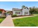 Community clubhouse with well-manicured lawn and landscaped entrance at 1241 S Akron Way, Denver, CO 80247