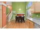 Sunlit dining area with staircase, complete with a wooden table, chairs, and a large window at 1241 S Akron Way, Denver, CO 80247