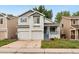 Charming two-story home featuring a well-maintained front yard and a convenient two-car garage at 1241 S Akron Way, Denver, CO 80247