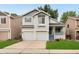 Charming two-story home with a two-car garage, covered porch, and well-maintained lawn at 1241 S Akron Way, Denver, CO 80247