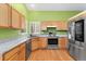 Well-lit kitchen featuring stainless steel appliances, granite countertops, and ample cabinet space at 1241 S Akron Way, Denver, CO 80247