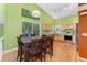Eat-in kitchen with stainless steel appliances, granite counters, and a wooden dining set at 1241 S Akron Way, Denver, CO 80247